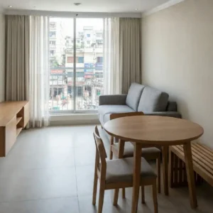 Small living room interior with a slim-depth sofa and a wall-mounted floating TV cabinet to maximize floor space.