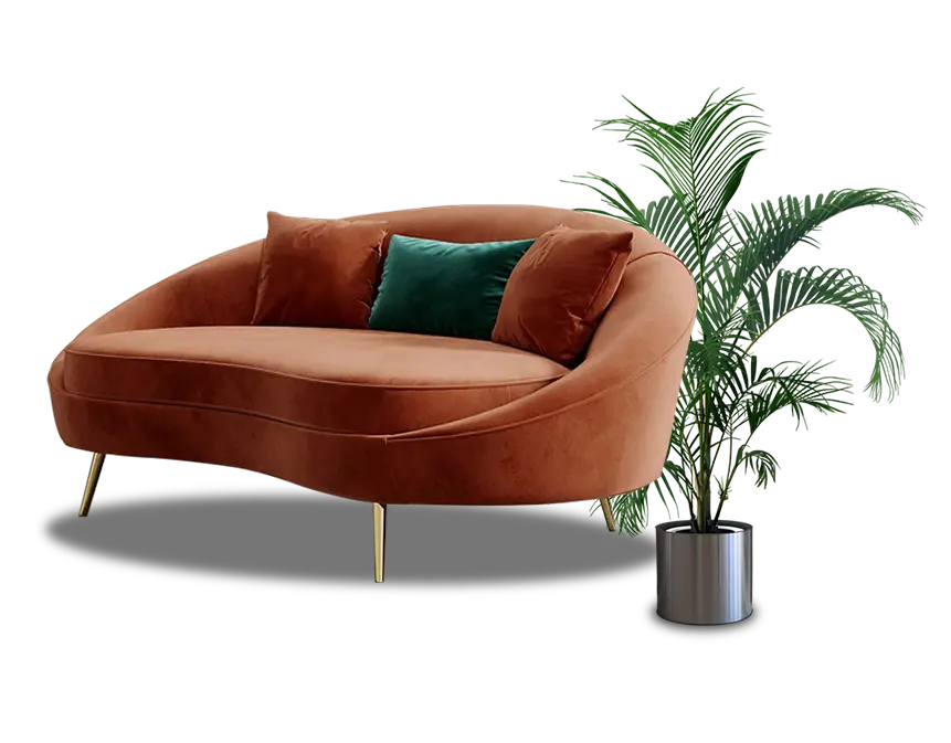 Stylish brown velvet sofa with gold legs and green & brown cushions, paired with a plant, designed by Oak Wood Craft BD, Bangladesh.